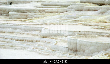 The Travertine pools of Pamukkale, Denizli city in Turkey. Pamukkale contains hot springs and travertines, terraces of carbonate minerals left by the Stock Photo