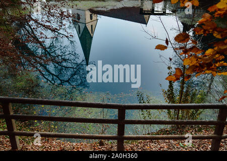 Rustic church roof reflected on the pond in the heritage town of Bernkastel-kues in Germany which is a popular tourist destination Stock Photo