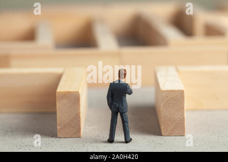 Businessman in the maze as a symbol of solving problems and finding a good way out Stock Photo