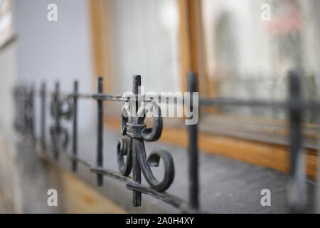 Fragment of the fence of the first floor windows on the facade of the building Stock Photo
