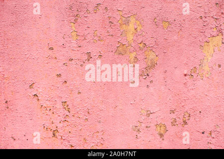 Old peeling paint on a pink metal surface. Textured background. Great for design and texture background. Stock Photo