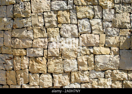 Wall of large square yellow stones, stacked blocks. Great for design and texture background. Stock Photo