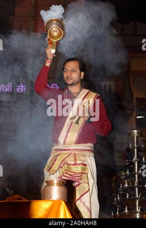 Priest celebrating the Aarti by offering incense, Dashashwamedh Ghat, Varanasi, Uttar Pradesh, India Stock Photo