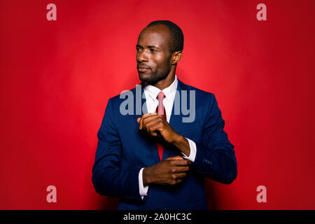 Portrait of imposing elegant handsome confident success professional man in white shirt deep blue formal wear look aside fasten clasp on wrist isolate Stock Photo
