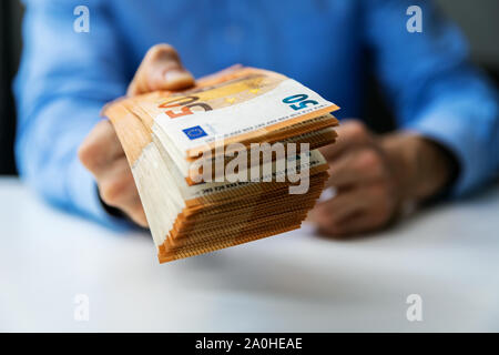 salary, money loan or prize concept - hand gives cash money Stock Photo
