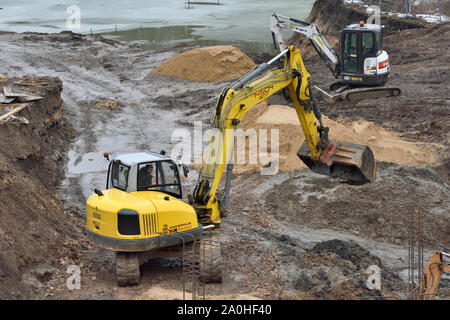 Vilnius, Lithuania - February 16: Excavators on construction site on February 16, 2019. Vilnius is the capital of Lithuania and its largest city. Stock Photo