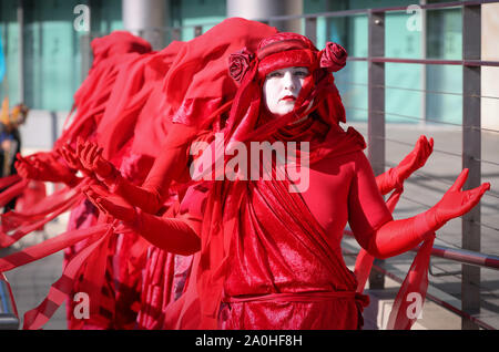 Southampton, UK 20th September 2019. Extinction Rebellion' Red Rebels and climate change campaigners protest outside of Carnival House in Southampton before marching through the streets of Southampton as part of the Global Strike international protest. Credit Stuart Martin/Alamy Live News Stock Photo
