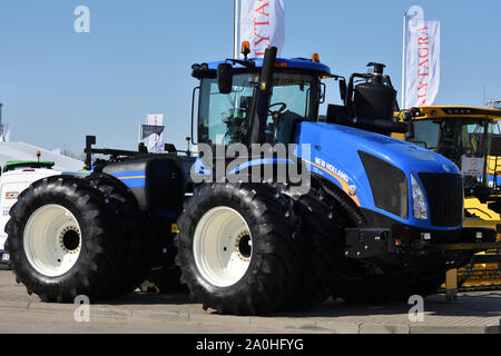 Kaunas, Lithuania - April 04: New Holland tractor and logo in Kaunas on April 04, 2019. New Holland is a global brand of agricultural machinery produc Stock Photo