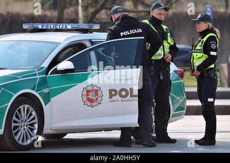 Vilnius, Lithuania - April 06: Police car and police officers in Vilnius Old Town on April 06, 2019 in Vilnius Lithuania. Vilnius is the capital of Li Stock Photo