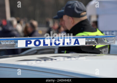 Vilnius, Lithuania - April 06: Police car and police officers in Vilnius Old Town on April 06, 2019 in Vilnius Lithuania. Vilnius is the capital of Li Stock Photo