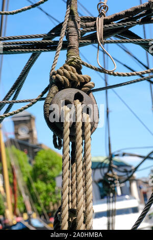 close up view of wooden sailing block and rigging on old sailboat Stock Photo