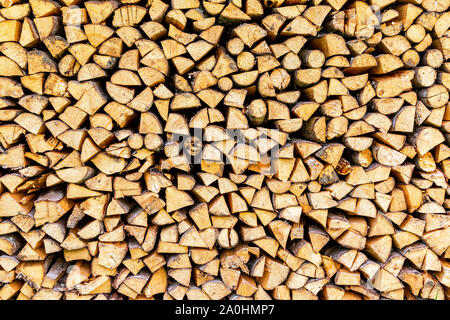 Chopped and stacked up dry firewood as background texture Stock Photo