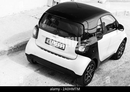 Cirkewwa, Malta - August 29, 2019: Black white SMART car stands on a roadside, black and white photo, rear view Stock Photo