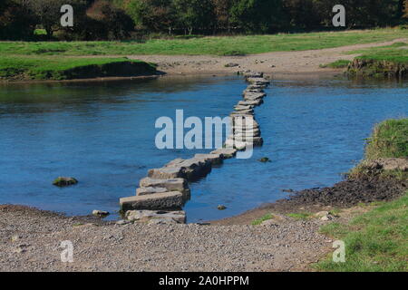 The well known stepping stones of Ogmore castle ruins in the quiet village of Ogmore near Bridgend in South Wales. Stock Photo