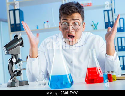 The funny mad chemist working in a laboratory Stock Photo