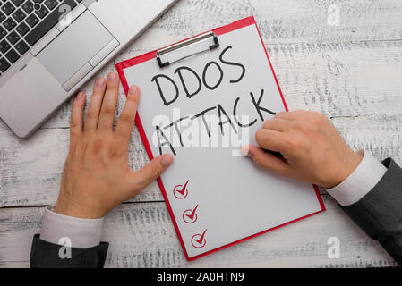 Handwriting text writing Ddos Attack. Conceptual photo perpetrator seeks to make network resource unavailable Stock Photo