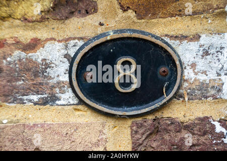 House number 8 on a metal plate Stock Photo