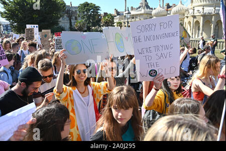 Brighton UK 20 September 2019 - Thousands of protesters march past the Royal Pavilion as they take part in the Global Climate Strike protest through Brighton . Adults have been urged to join thousands of children taking part in the worldwide protests against the lack of action by government in combating climate change Credit : Simon Dack / Alamy Live News Stock Photo