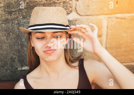 Face portrait of posing beautiful blond European girl in a straw hat Stock Photo