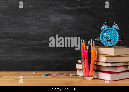 Back to school background with books and alarm clock Stock Photo - Alamy