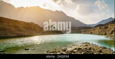 Scenic view of Hatta Lake and Hajar Mountains in the Emirate of Dubai, UAE Stock Photo