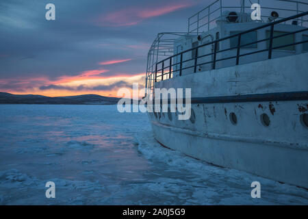 Ships stranded on Baikal icea at Sunset Stock Photo
