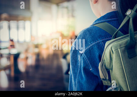 Girl with backpack entering to the classroom, Education concept. Stock Photo