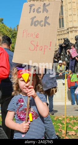 Westminster, London, UK, 20th Sep 2019. Young Imogen has travelled to the protest with her parents and friends. Tens of thousands of children, young people and adults protest for climate action and against the causes of climate change in the British capital. Many similar protests take place in cities around the world in a day of global climate action in an event sparked by the young campaigner Greta Thunberg who attends the global climate strike in New York. Credit: Imageplotter/Alamy Live News Stock Photo