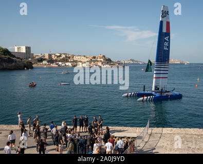 The France SailGP Team’s F50 catamaran sits on the water as Billy Besson and his crew attend a photocall on the quayside ahead of Race Day 1. The final SailGP event of Season 1 in Marseille, France. Stock Photo