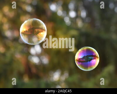 The reflection of a house in two  soap bubbles Stock Photo
