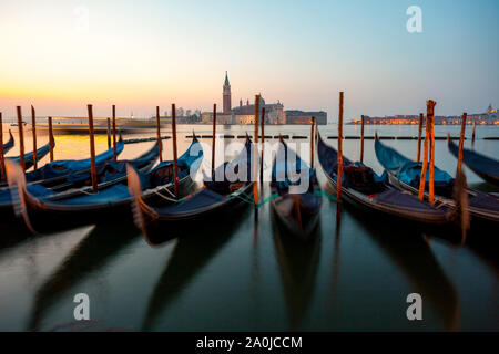 Sunrise in Venice, gondolas and island of St. George view from the square San Marco. Travel. Stock Photo