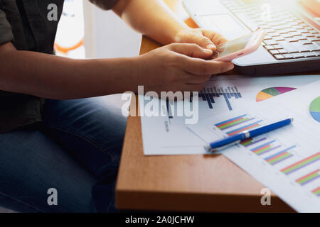 Hands of people using mobile phone on office desk, Business concept. Stock Photo