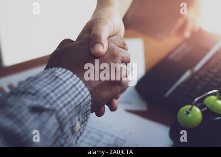 Two colleague shaking hands together celebrating finished work. Business concept. Stock Photo