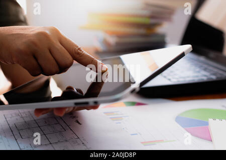 Hands of woman using tablet on working desk in office. Business and Technology concept. Stock Photo