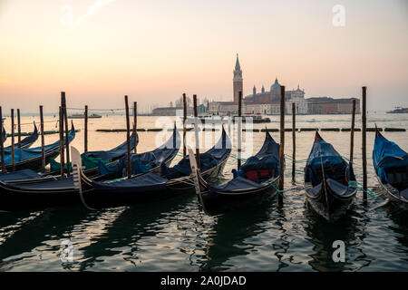 Sunrise in Venice, gondolas and island of St. George view from the square San Marco. Travel.