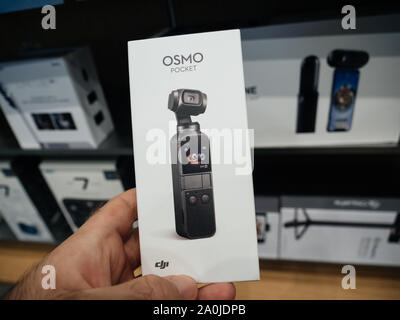 Paris, France - Sep 20, 2019: Man hand holding new DJI OSmo Pocket action camera with display Stock Photo