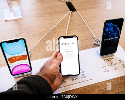 Paris, France - Sep 20, 2019: Man hand holding new iPhone 11 Pro and Pro Max are displayed in Apple Store as the smartphone by Apple Computers goes on sale Stock Photo