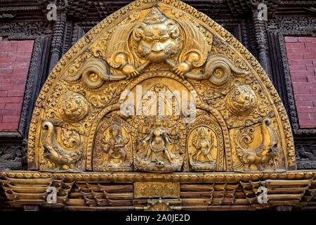 Various embodiment of Hindu Gods carved on a metal plate in Patan Durbar Square. Stock Photo