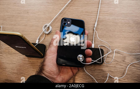 Paris, France - Sep 20, 2019: View from above of man hand holding black new iPhone 11 in Apple Store as the smartphone by Apple Computers goes on sale Stock Photo