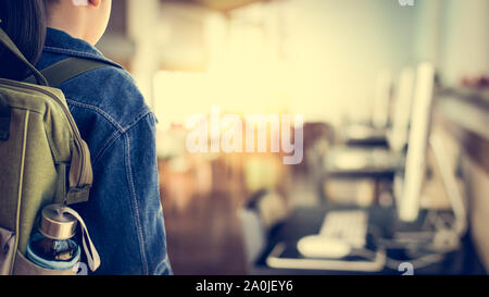 Girl with backpack entering to computer classroom, Education concept. Stock Photo