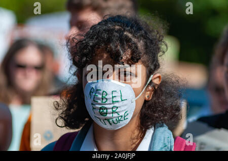 Glasgow, Scotland, UK. 20th September, 2019. A protester wearing a face mask saying Rebel For Future during the march through the streets of Glasgow from Kelvingrove Park to George Square as they attend the Global Climate Strike demonstration to demand action on the world's climate crisis. Credit: Skully/Alamy Live News Stock Photo