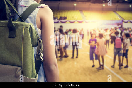 Girl with backpack attend school activities in indoor stadium, Education concept. Stock Photo