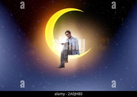 The student reading book on the moon crescent Stock Photo