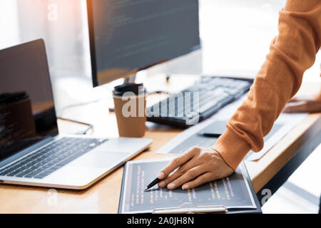 Pensive programmer working on on desktop pc programming code technologies or website design at office Software Development Company. Stock Photo