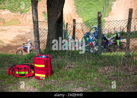 Giavera del Montello, Italy. 14 September 2019. Paramedics bags laying next to a tree with motorcyclists in the background. Credit: Lukasz Obermann/Alamy Live News Stock Photo