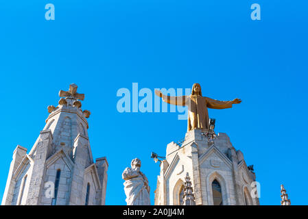 Golden Statue of Jesus Christ on the facade of the Temple of the Sacred Heart of Jesus, Barcelona, Catalonia, Spain. Copy space for text Stock Photo