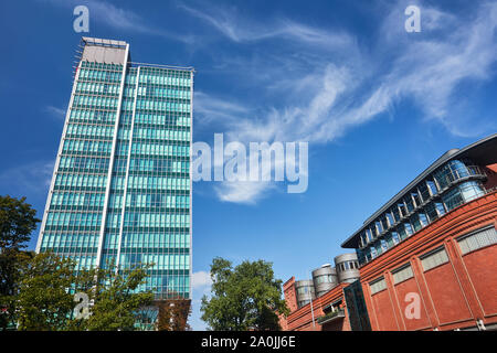 Walls and towers of old brewery and modern office building in the city of Poznan Stock Photo