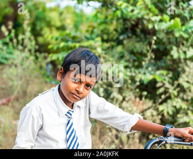 PUTTAPARTHI, INDIA - NOVEMBER 29, 2018: Indian boy in school uniform. With selective focus Stock Photo