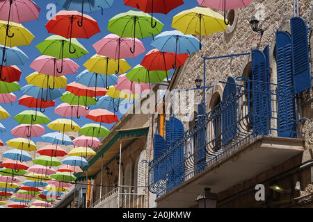 Colorful umbrellas are suspended above Nahalat Shiva alley a pedestrian promenade in West Jerusalem Israel