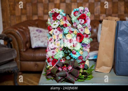 letter N made of flowers . alphabet made of flower letter n .Letter N made from colorful petals rose . Blue paper bag Stock Photo